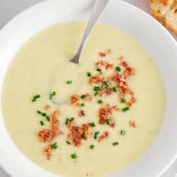 Potato leek soup in a white bowl.