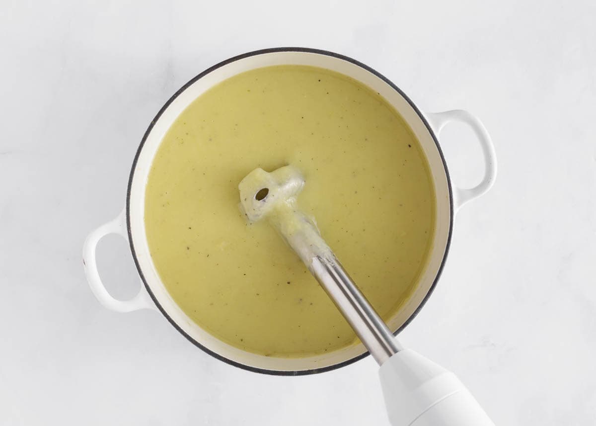 Using an immersion blender in the soup.