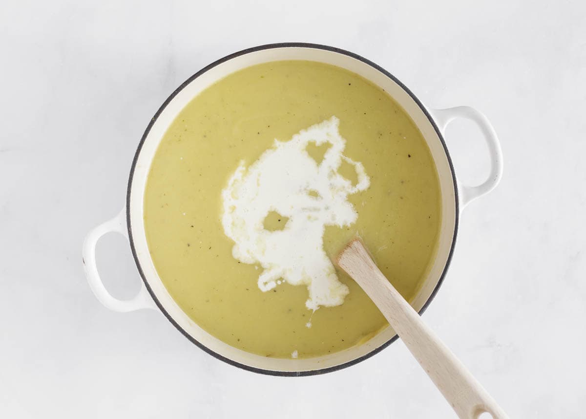 Adding cream to potato and leek soup