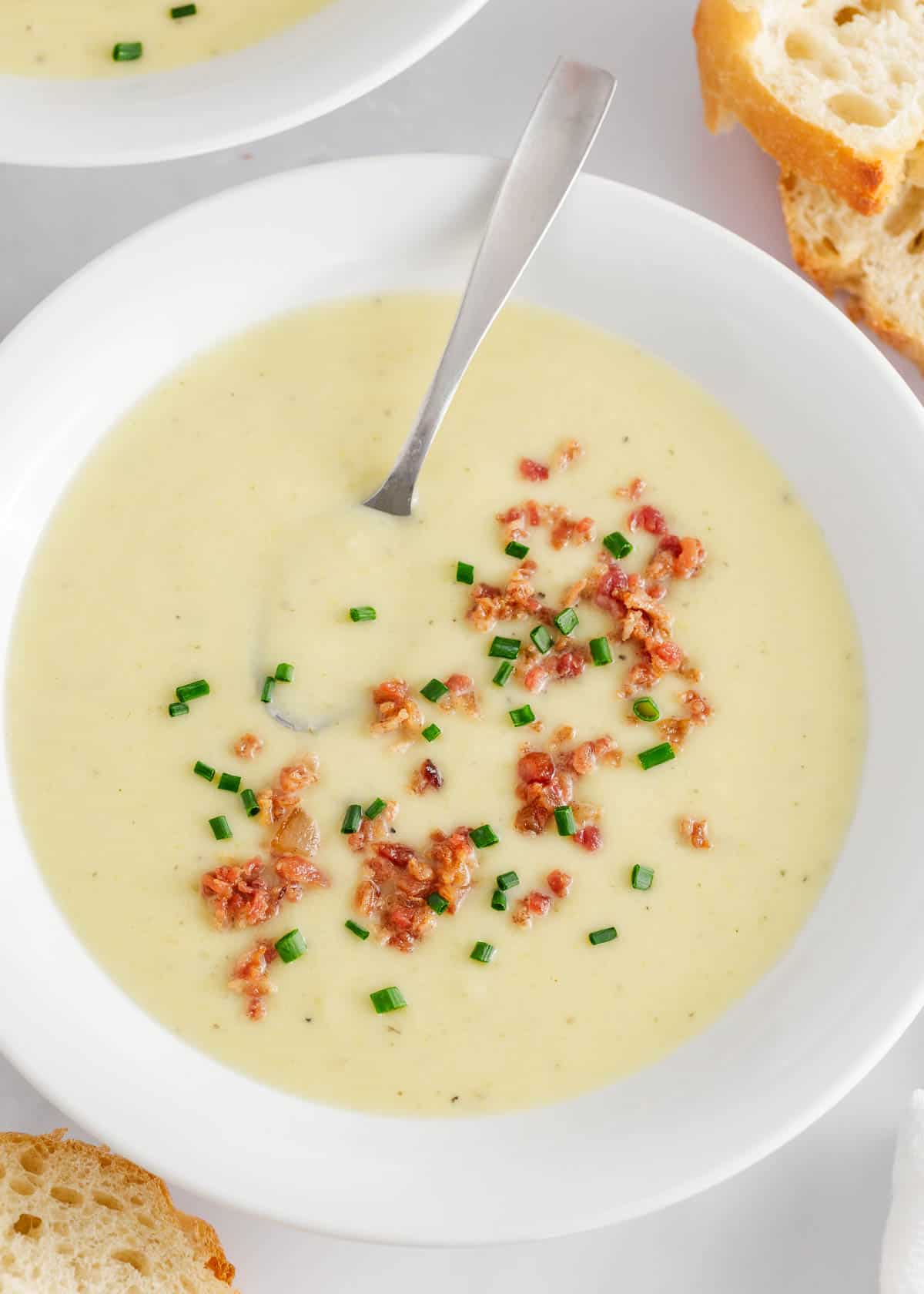 Potato leek soup in a white bowl.