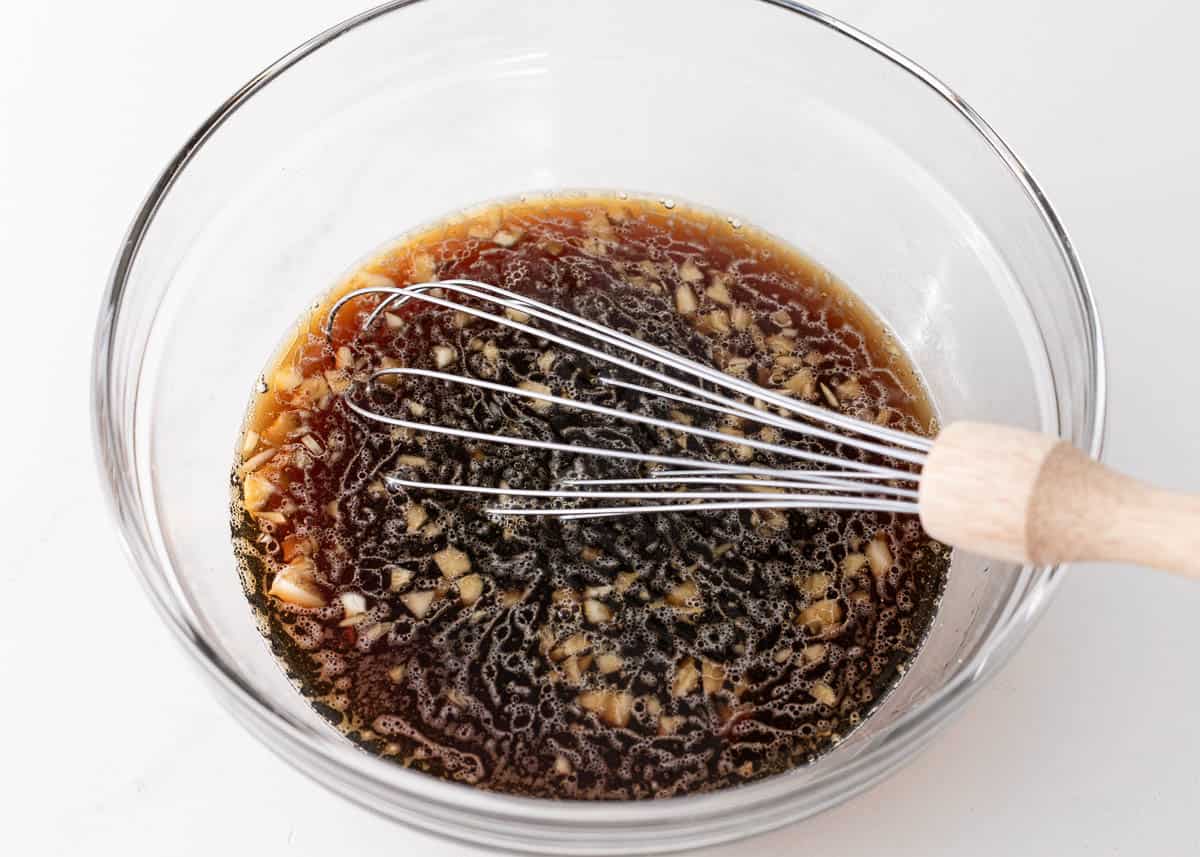 Whisking soy sauce mixture in a bowl.