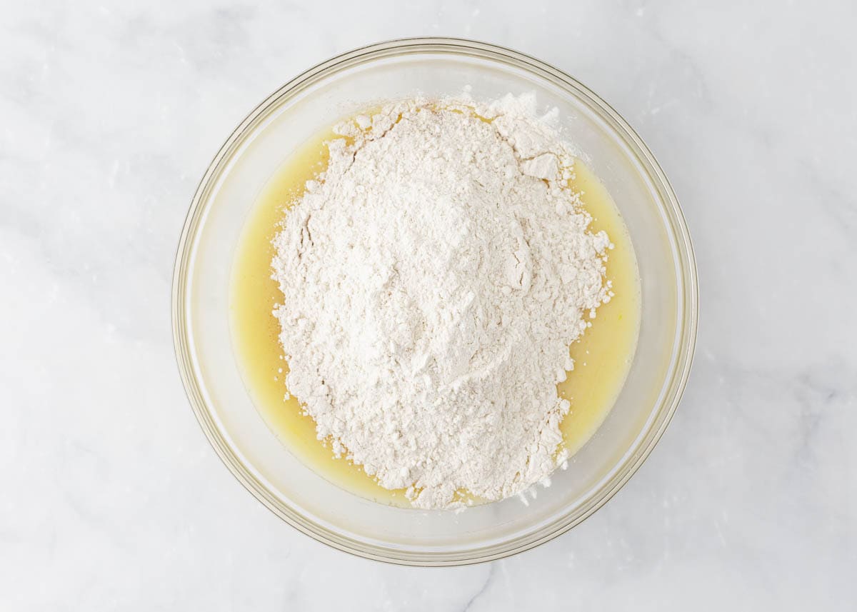 Egg mixture in a bowl with flour.