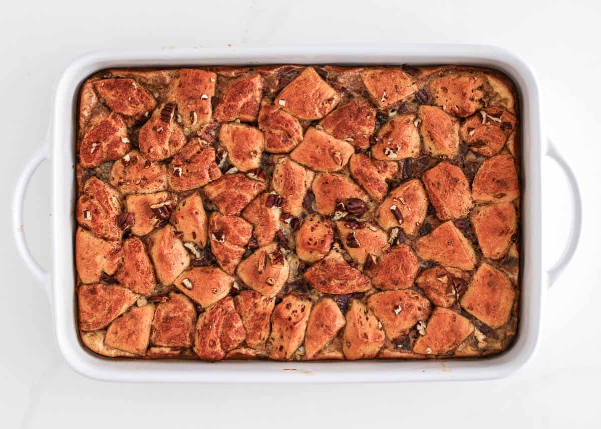 Cinnamon roll casserole assembled in baking dish. 