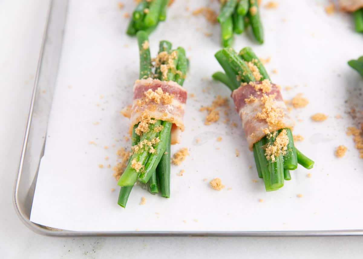 Green bean bundles with brown sugar on top.