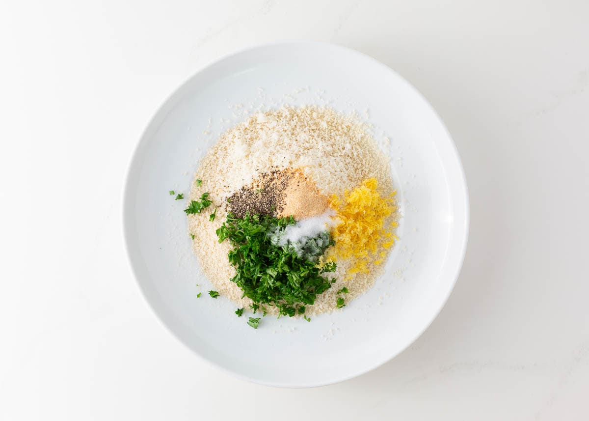 Panko, parmesan, lemon zest and seasonings in a bowl.