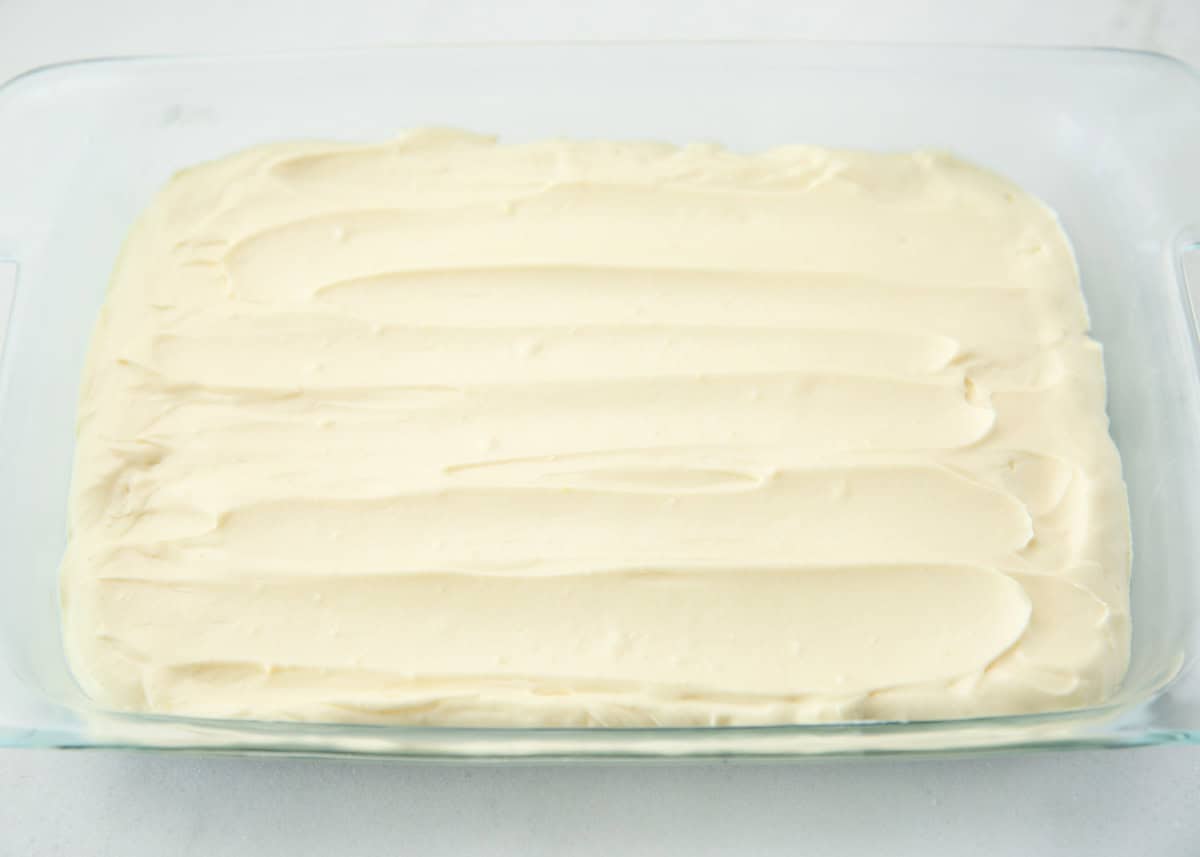 Pudding filling mixture over a Oreo crust in baking dish.