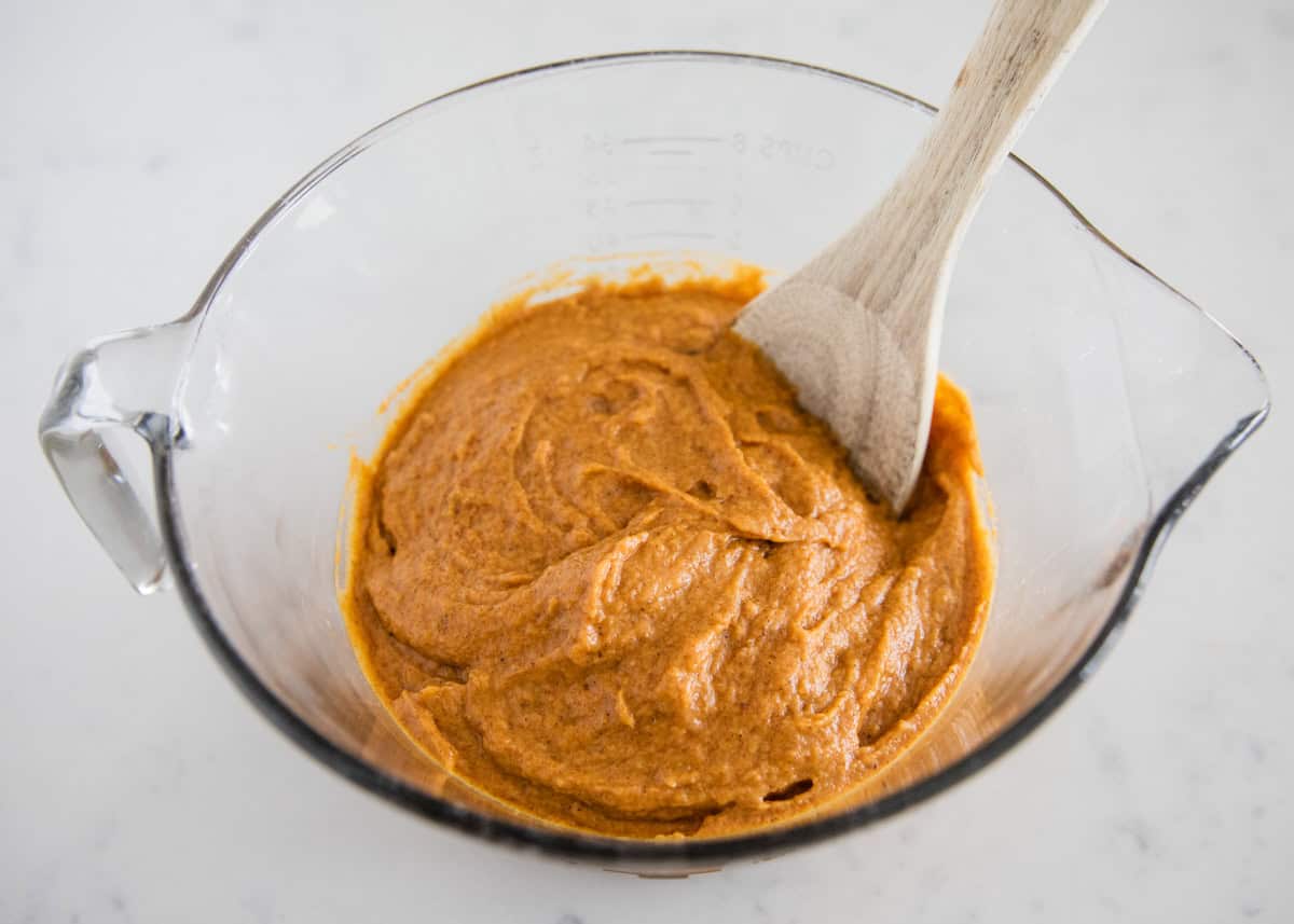 Pumpkin muffin batter in a large measuring bowl.