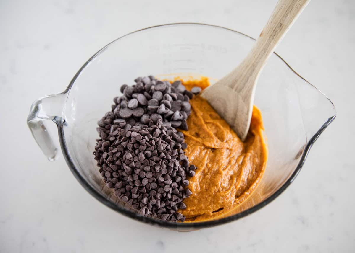 Pumpkin muffin batter with chocolate chips.