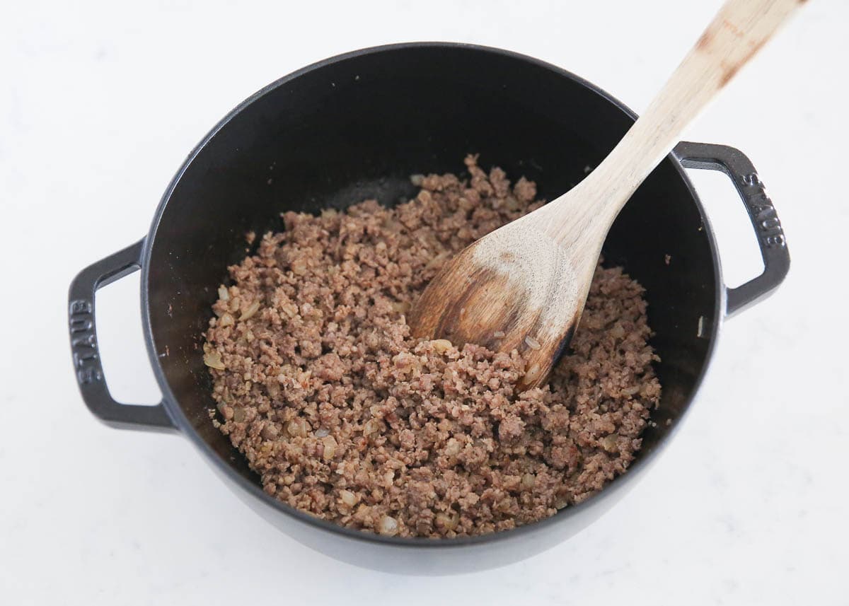 Browning sausage in a skillet.