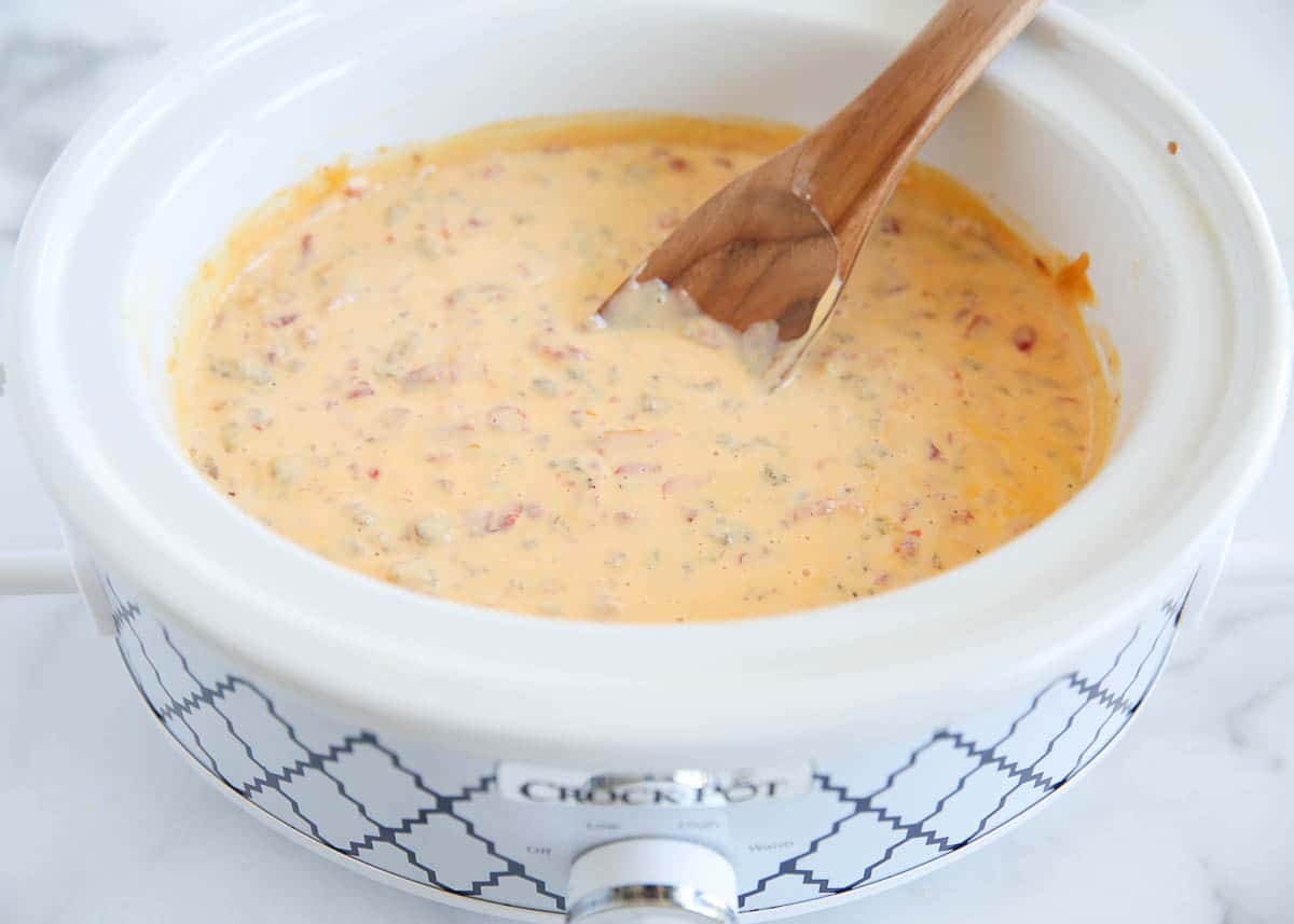 Stirring rotel sausage dip.