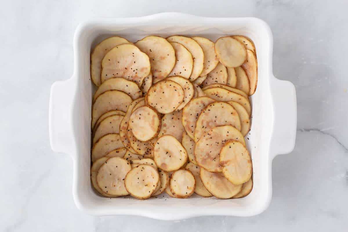 Sliced potatoes in a baking dish.