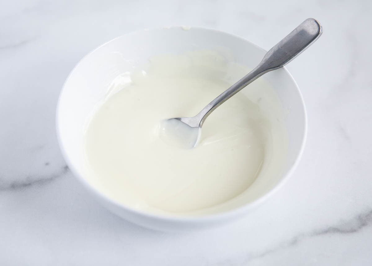 Melted white chocolate in a bowl.