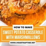 Sweet potato casserole with marshmallows in a baking dish with serving spoon.