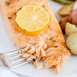 Baked salmon on a plate with veggies.