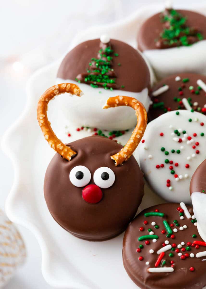 Chocolate covered Christmas Oreos decorated and on a plate.