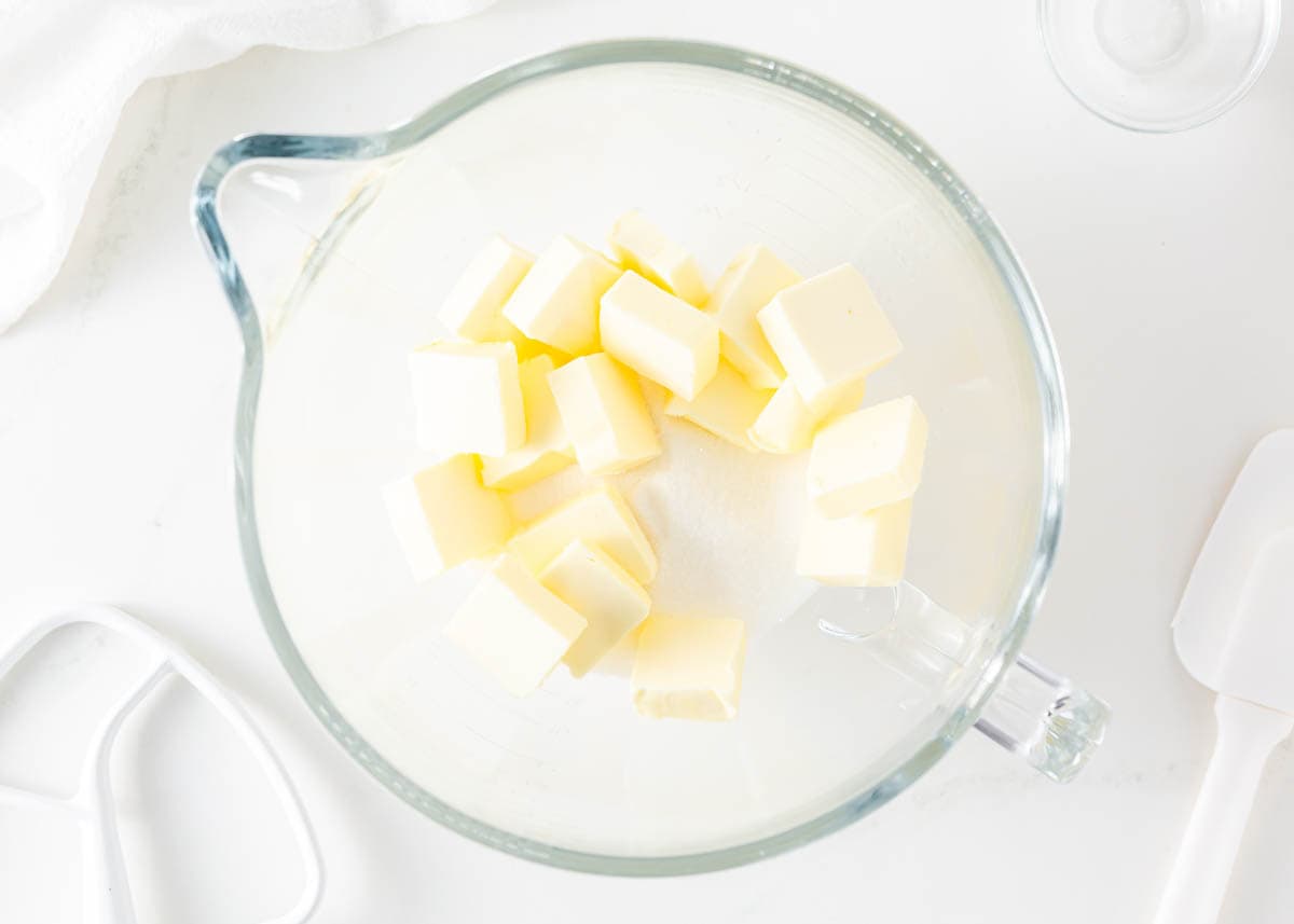 Sliced butter in a large glass measuring bowl.