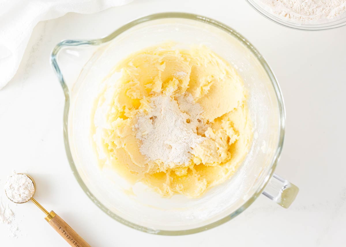 Creamed butter and sugar in a glass measuring bowl.