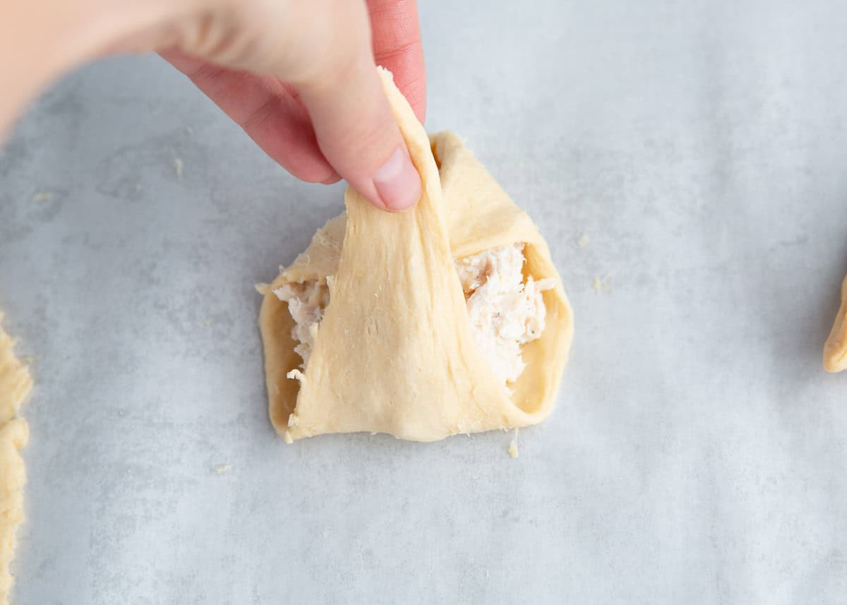 Rolling up a chicken crescent roll.