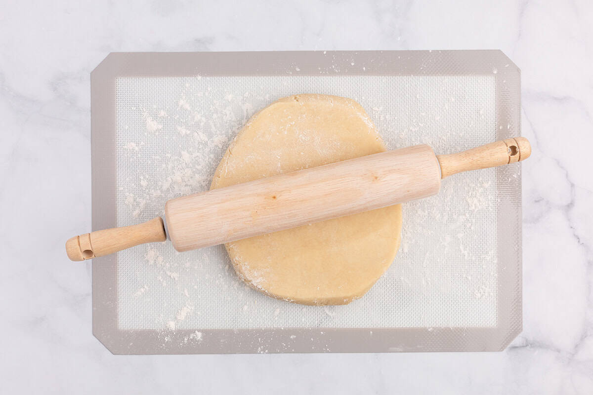 Rolling out sugar cookie dough.