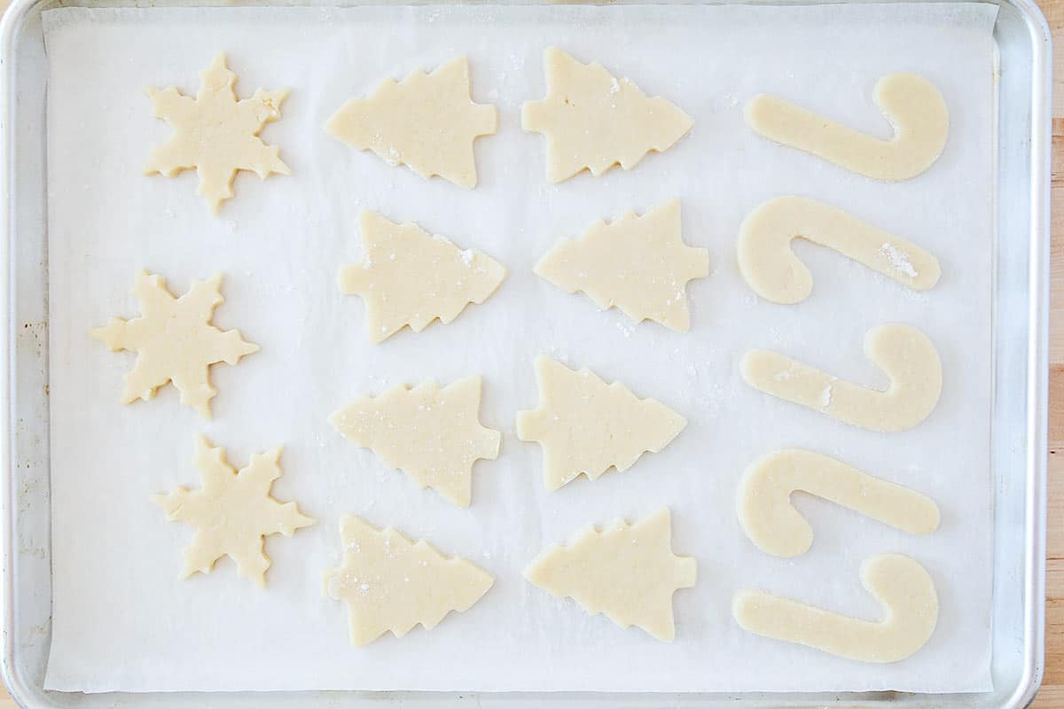 Cut out sugar cookie dough on baking sheet.