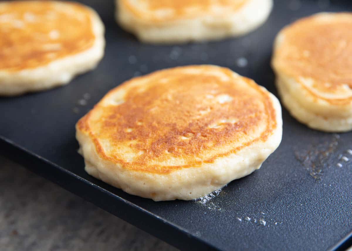 Homemade pancakes on a griddle.