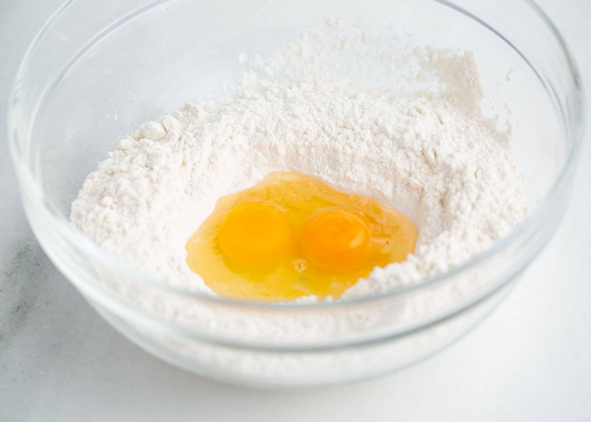 Flour in a bowl with a well in the center filled with
two eggs.