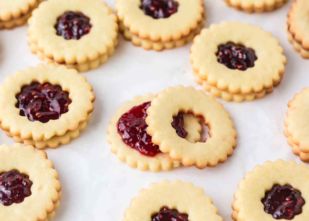 Filling linzer cookies with raspberry jam.