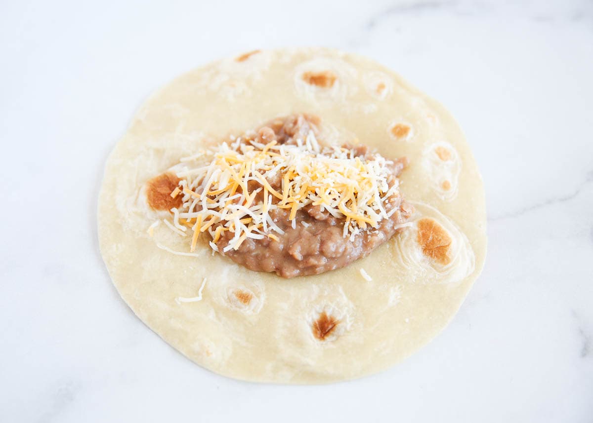 Beans and cheese spread into a tortilla.