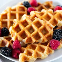 Croffle with berries on a plate.