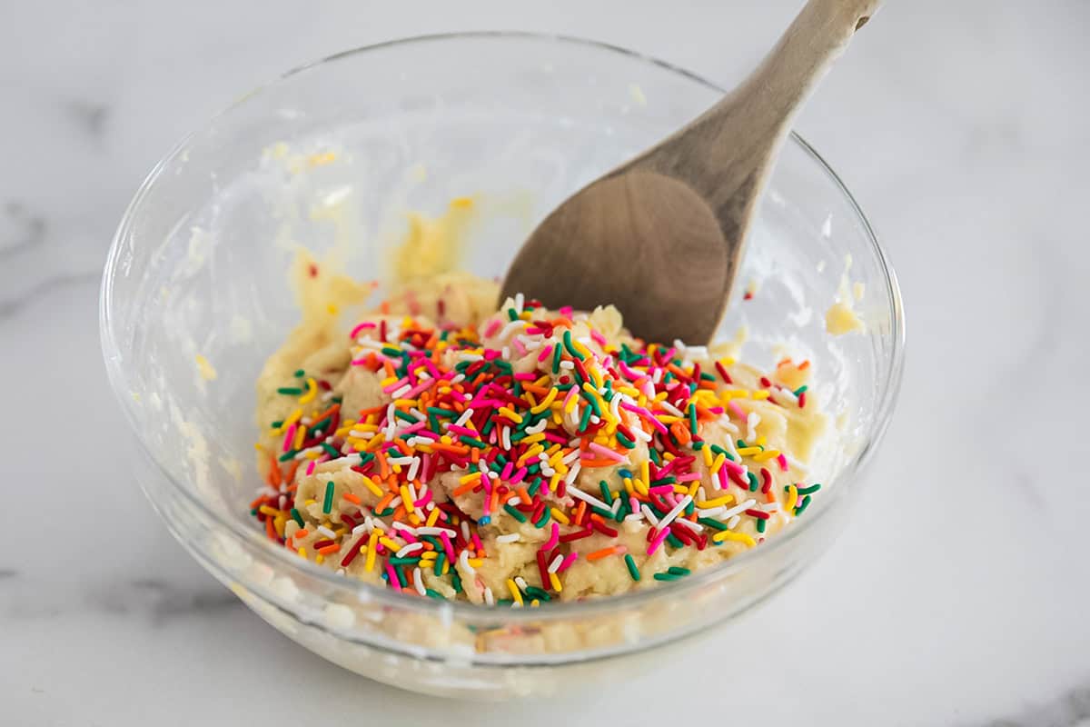 Funfetti cake mix with extra sprinkles in a bowl.