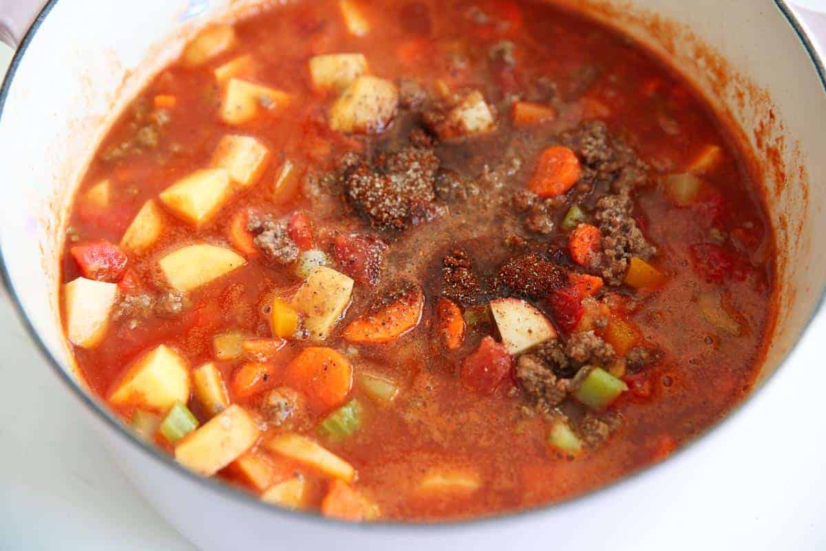 Hearty vegetable soup simmering in a pot.