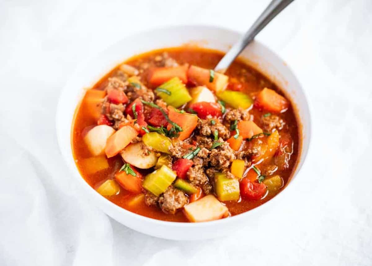 A bowl of hearty vegetable soup with beef.