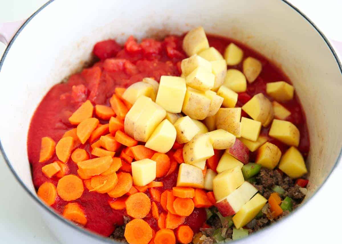 Hearty vegetable soup ingredients in a pot.