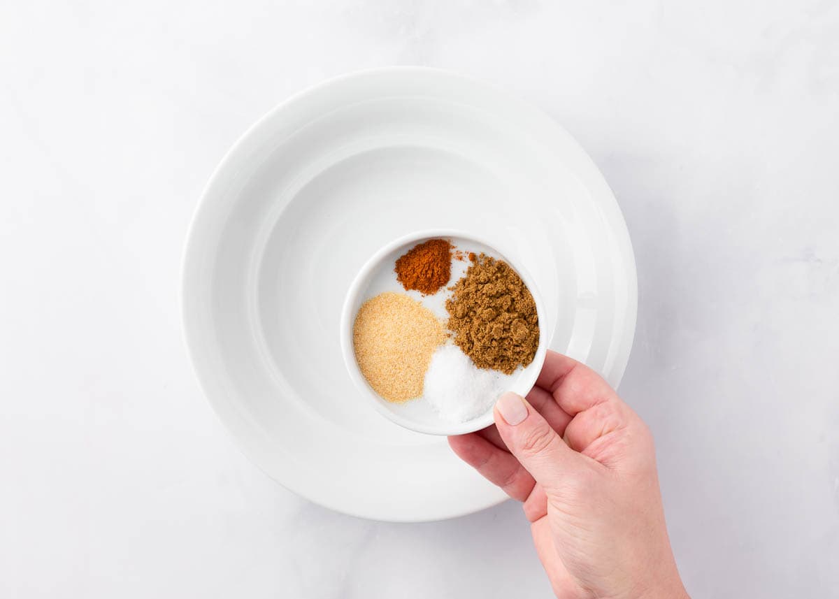 Cumin, salt, garlic powder, and cayenne pepper in a bowl.