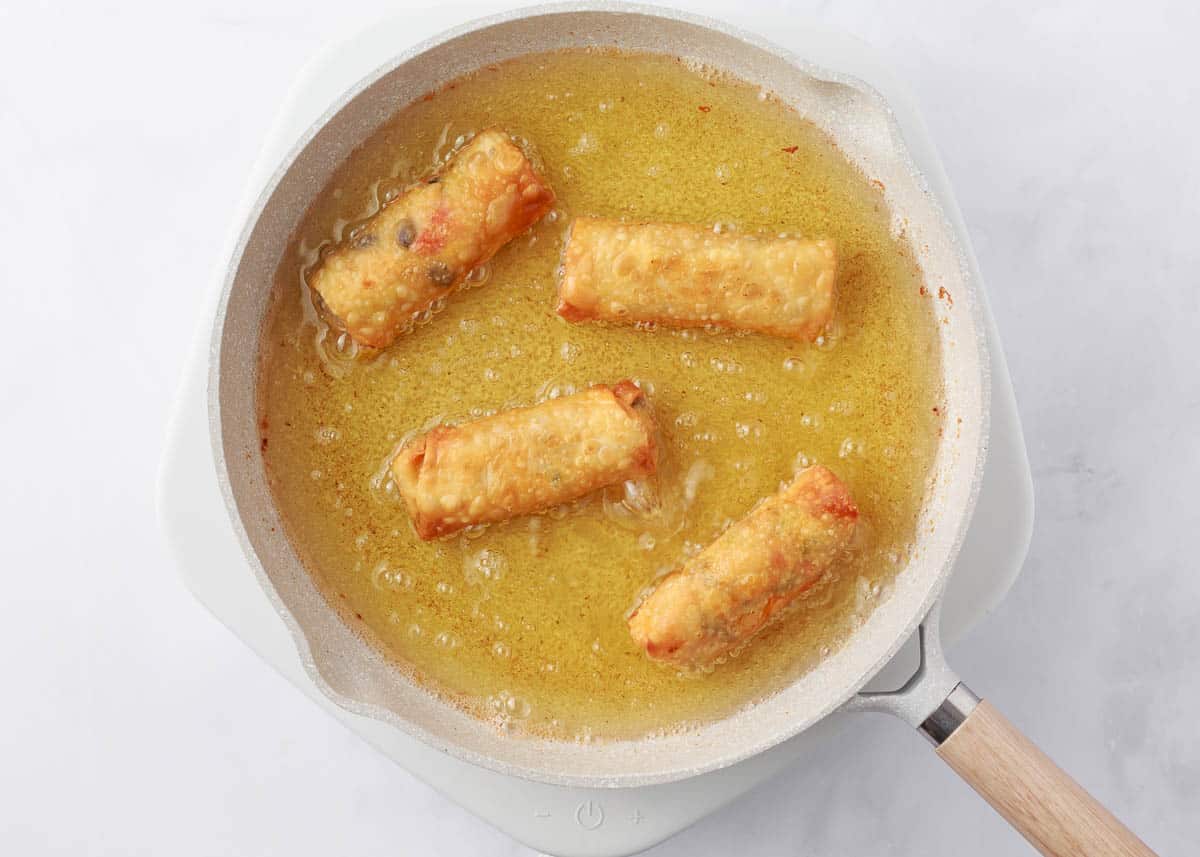 Frying southwestern egg rolls.