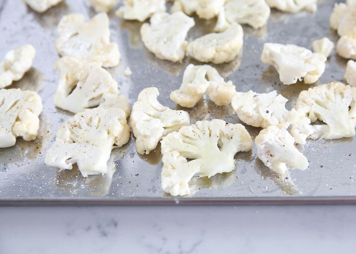 Seasoned cauliflower on a baking sheet.