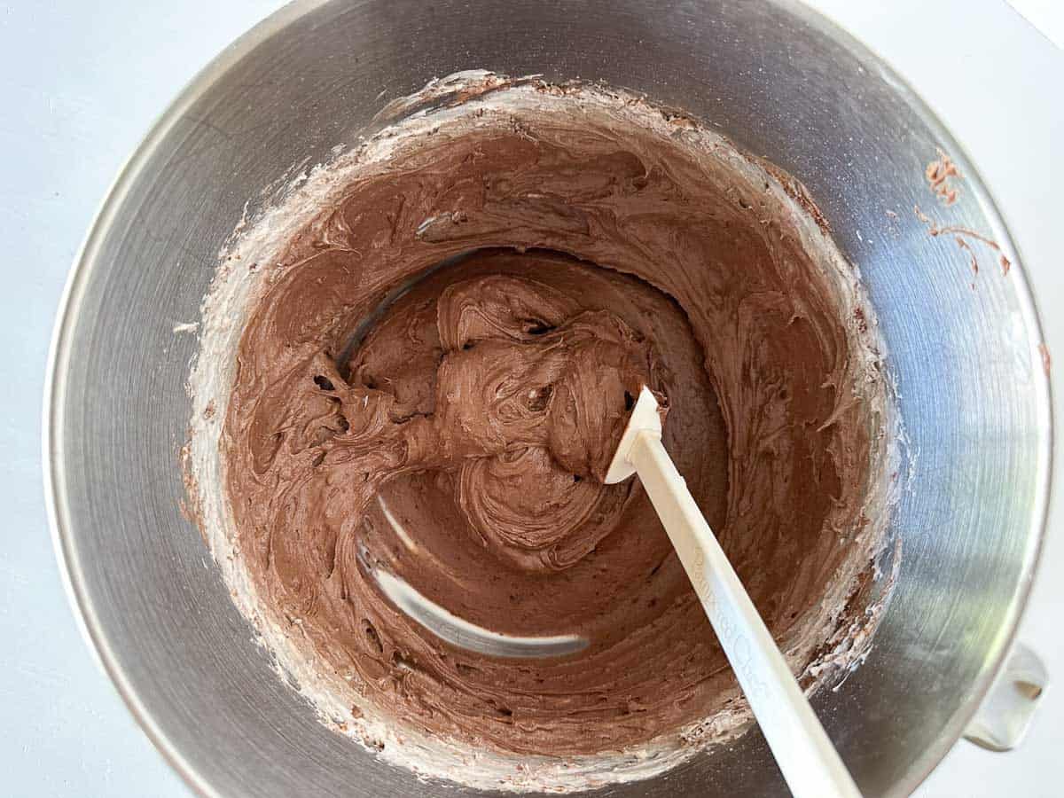 Mixing in brownie mix and cool whip into whipped cream cheese in a bowl.