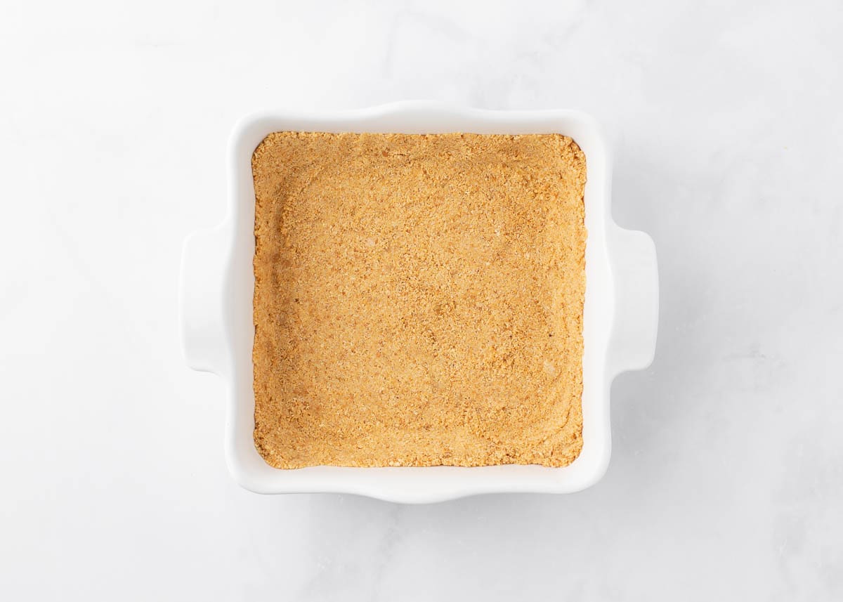 Graham cracker crust in baking dish.