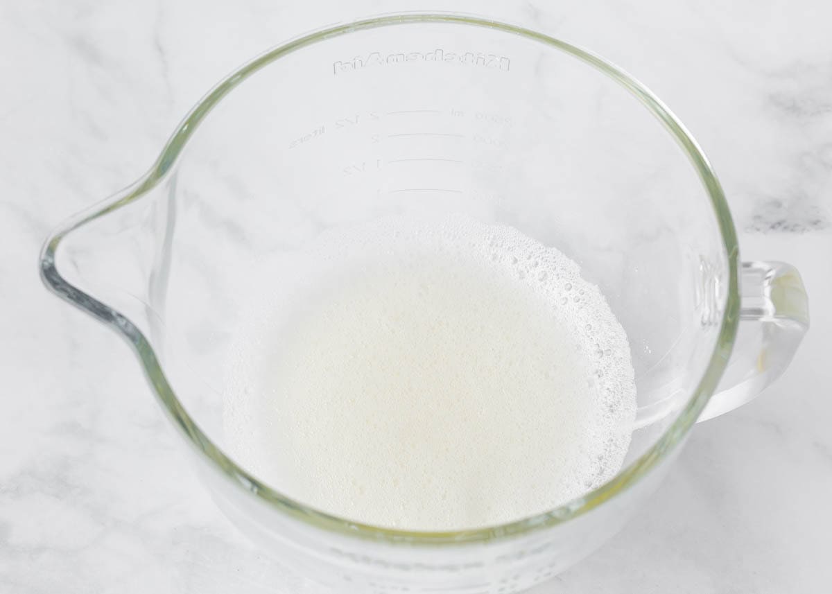 Egg whites and cream of tartar in a large mixing pitcher. 