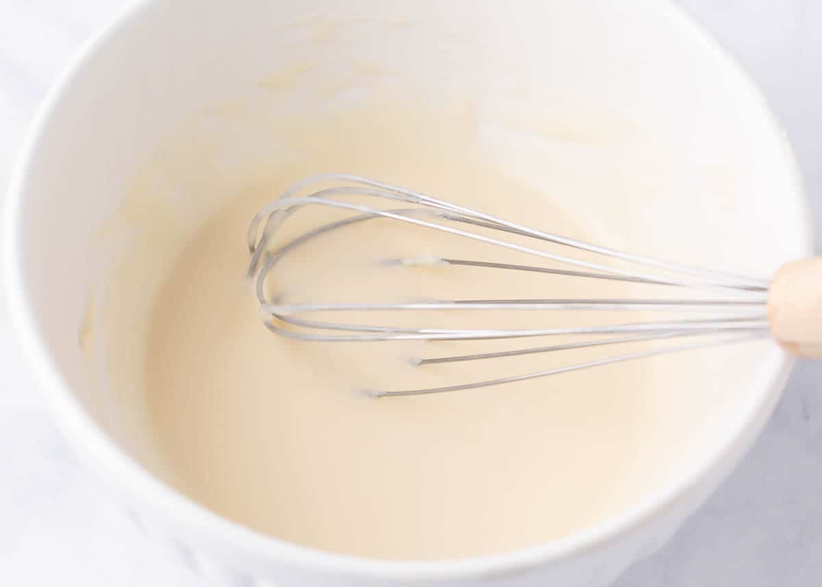 Whisking together a glaze for pistachio bread.