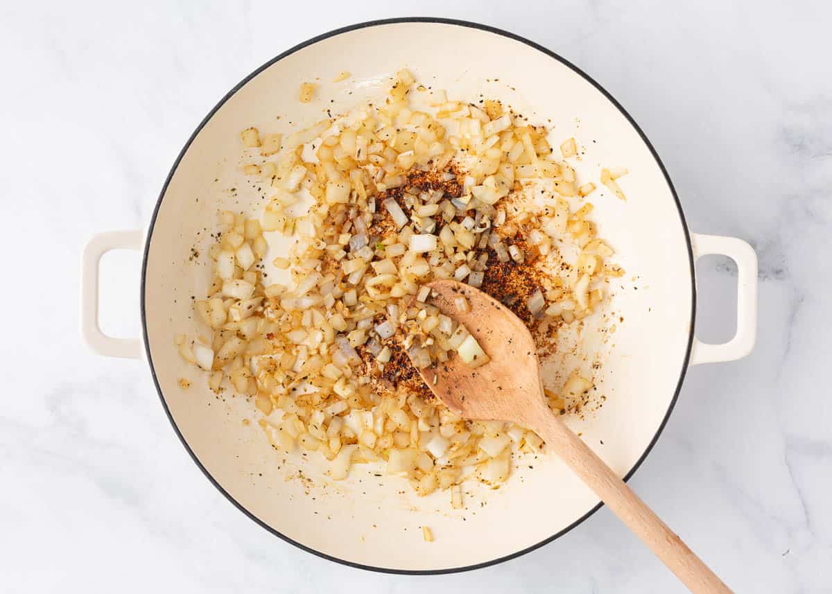 Sauteing onion and garlic in a skillet.