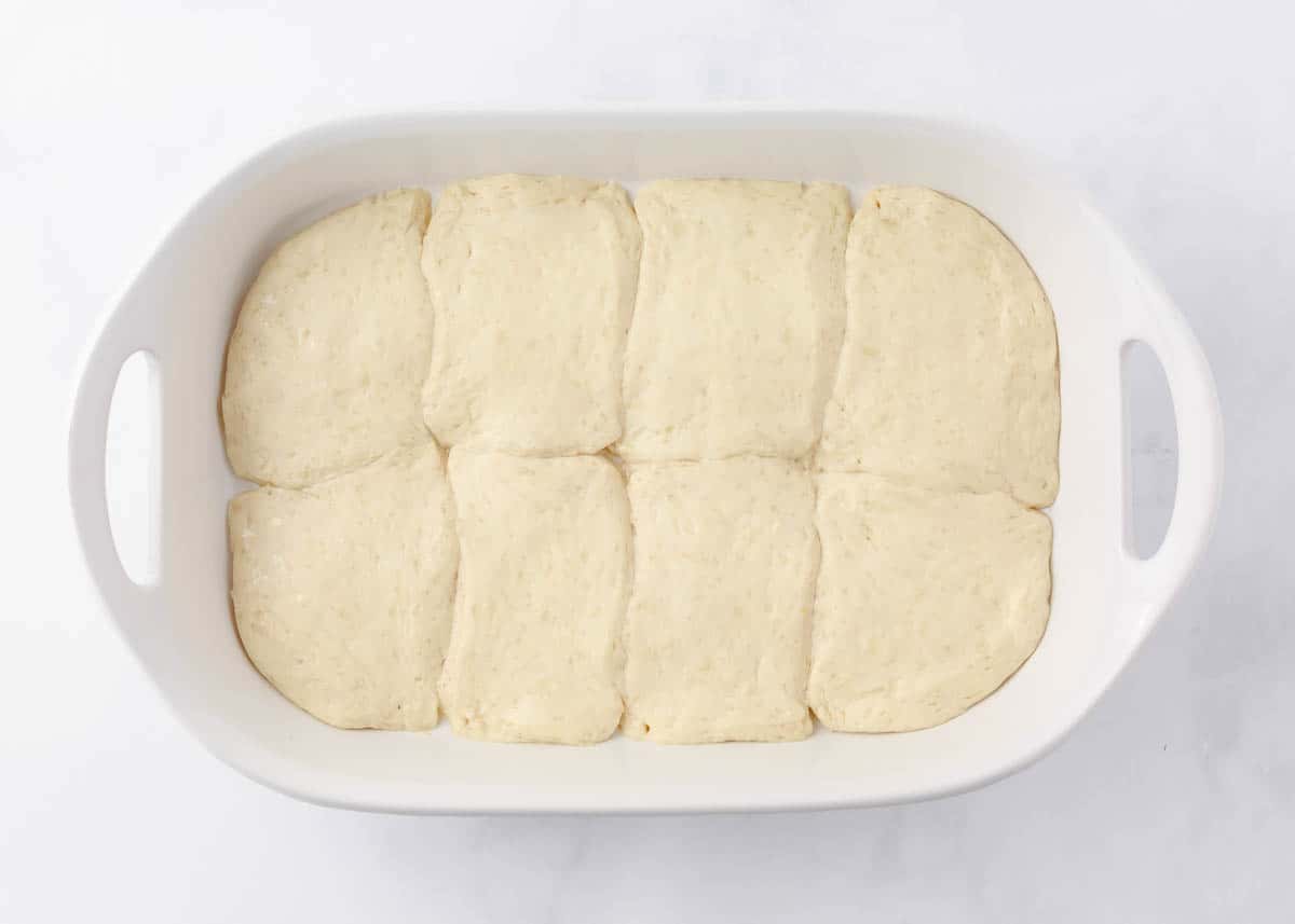 Biscuits in the bottom of a baking dish.