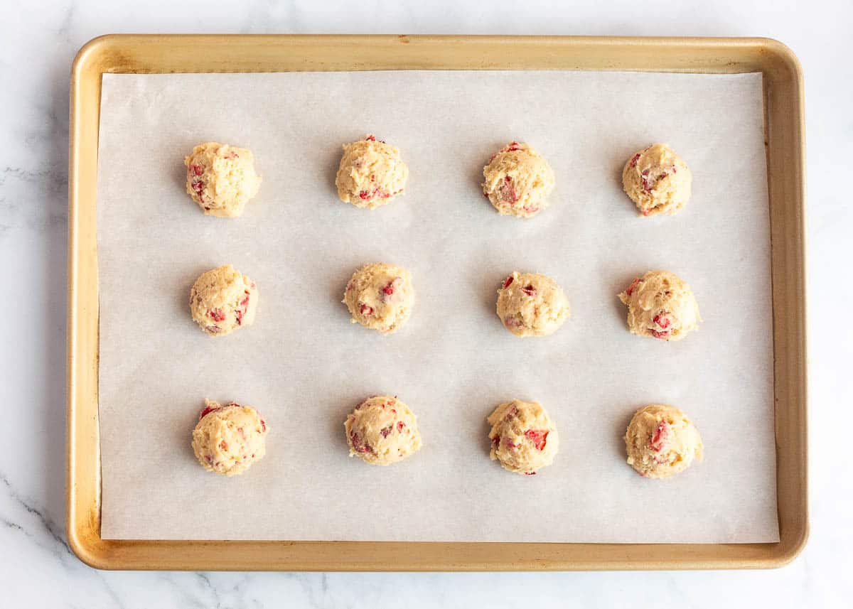 Strawberry cookie dough on parchment paper.