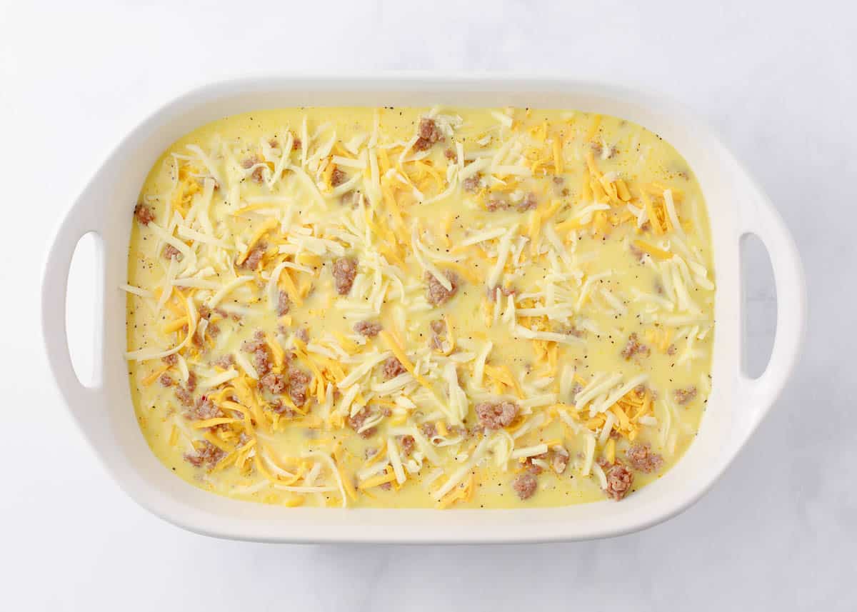 Unbaked assembled breakfast casserole with biscuits.