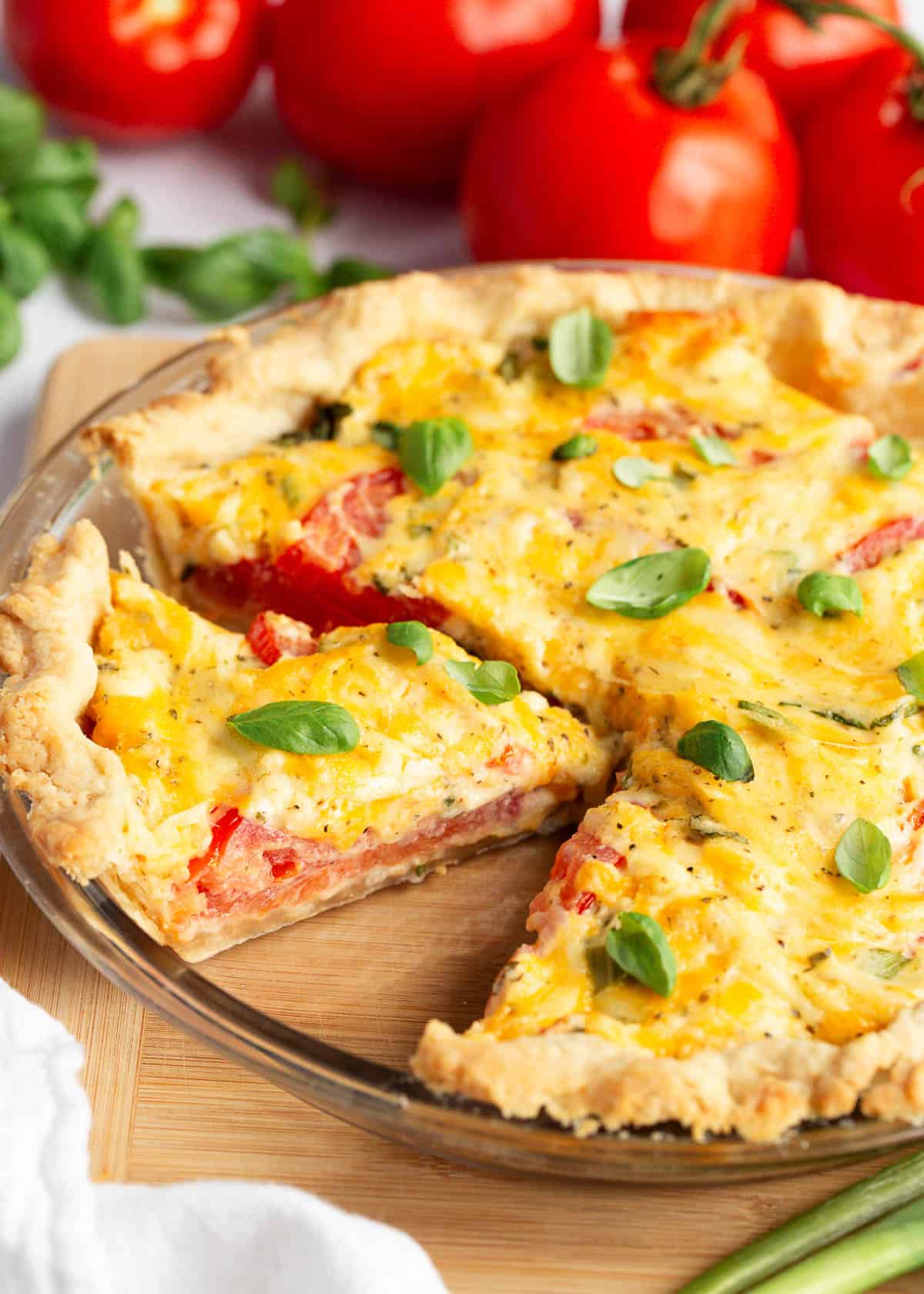 Sliced tomato pie in a pie dish.