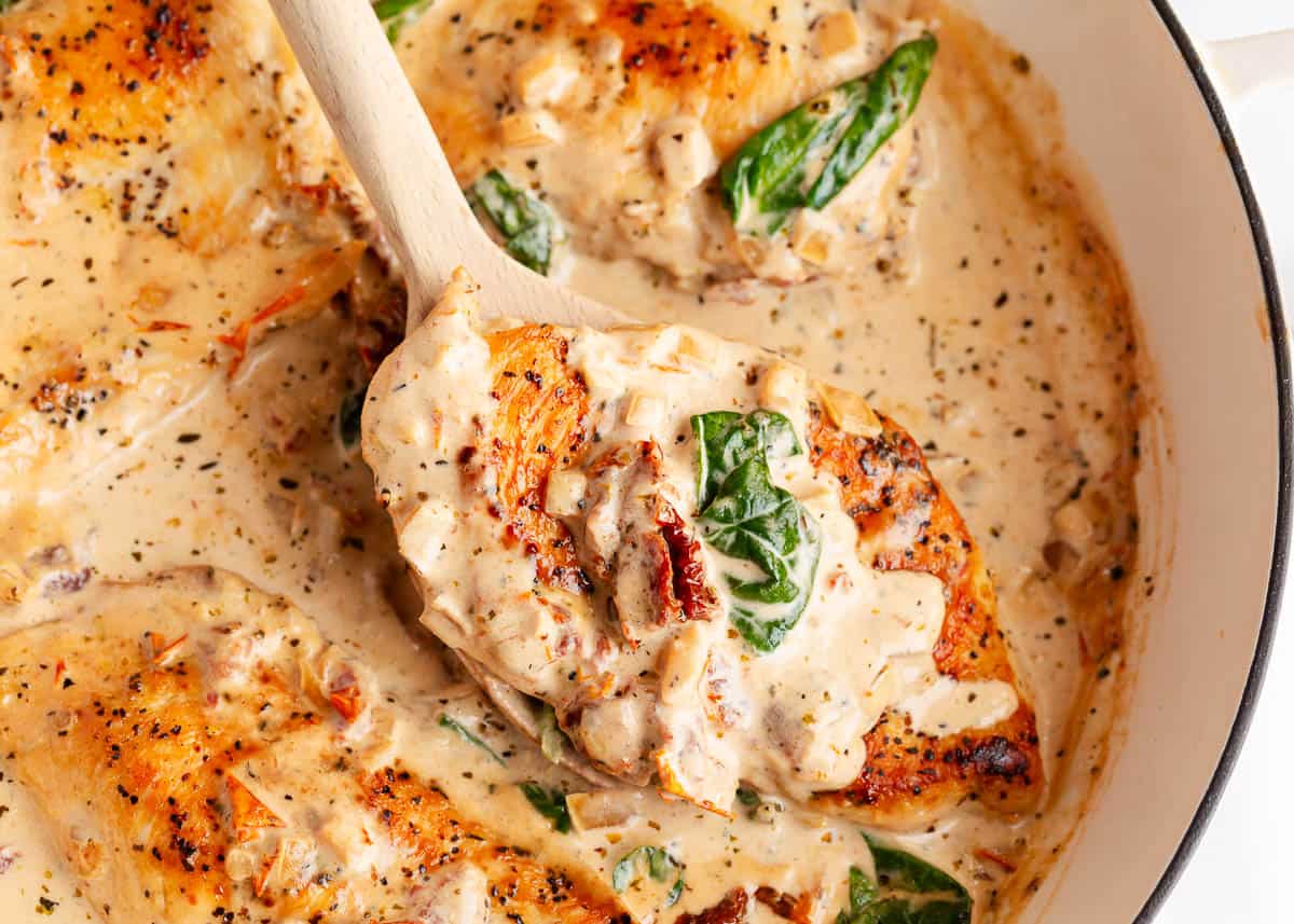 Tuscan chicken cooked in a skillet.