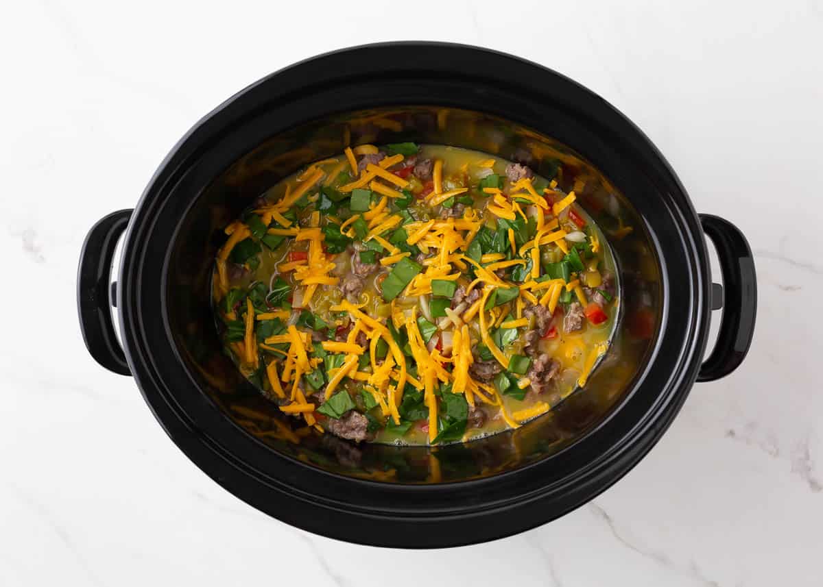 Unbaked crockpot breakfast casserole in slow cooker liner.