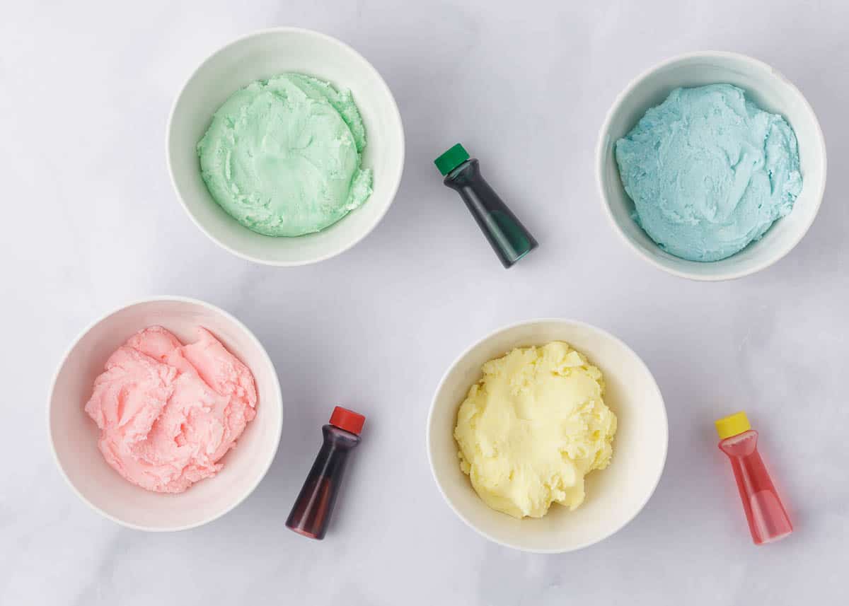 Cream cheese mint dough in bowls with pastel food colors.