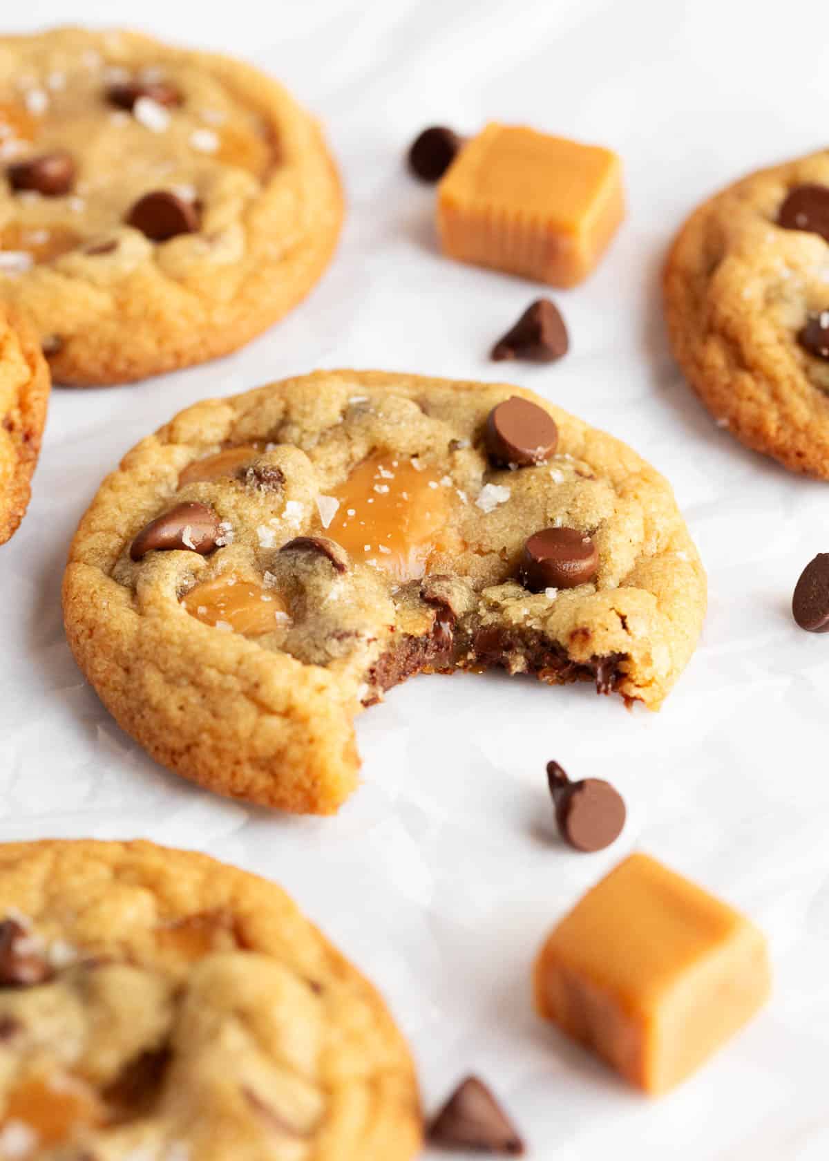 Caramel chocolate chip cookies with a bite taken.