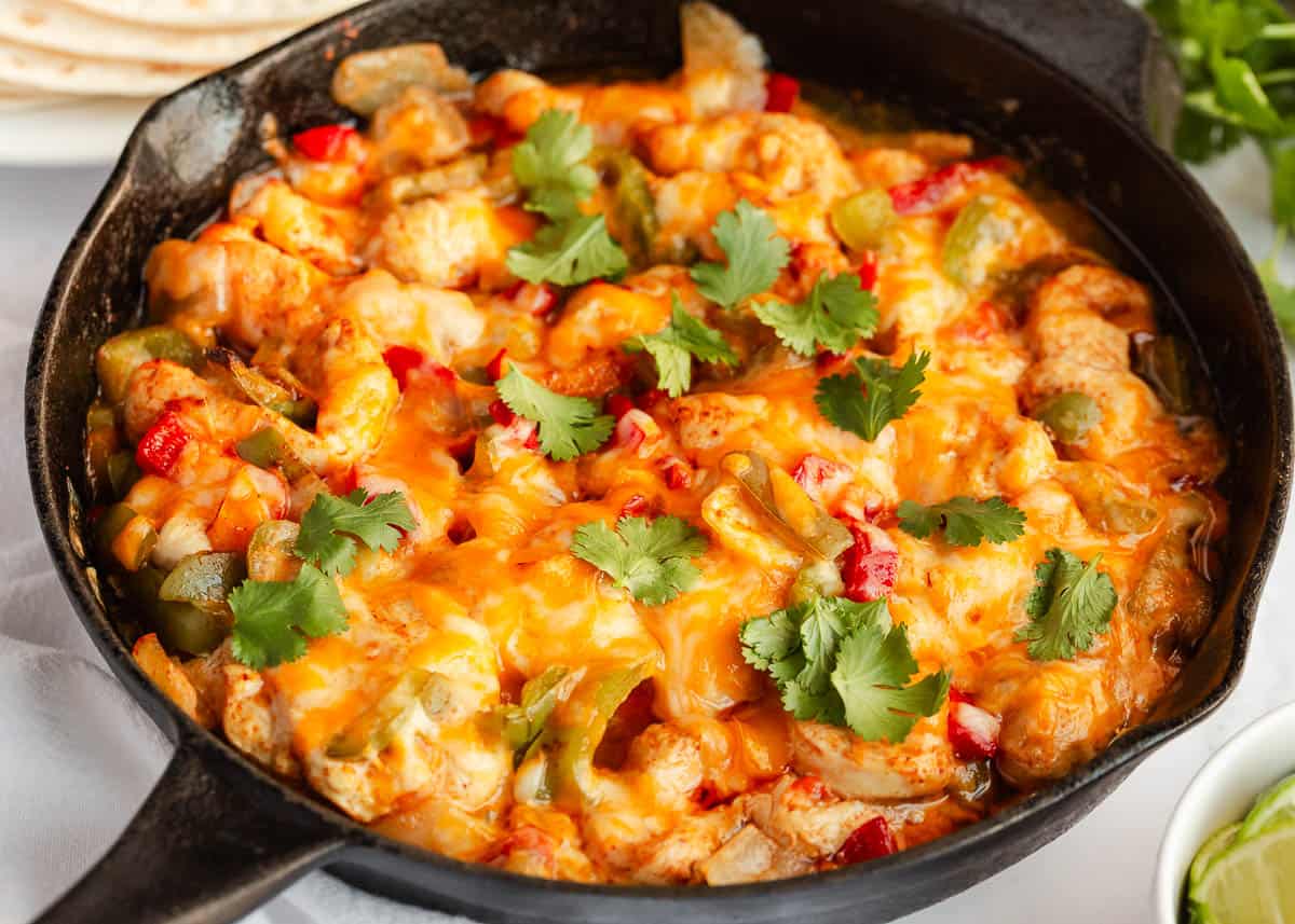 Chicken fajita casserole in a skillet.